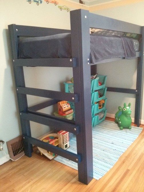 the bunk bed is built into the wall in the children's room, which also has toys