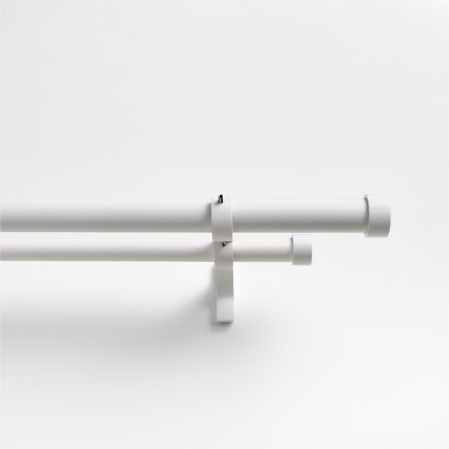 two white pipes are attached to the side of a wall, with one tube sticking out