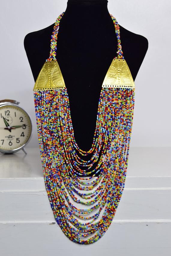 Unique Africa Maasai Handcrafted Beaded Necklace with an Elegant Look and Brilliant Finish.Color =Multi Color.Length (Around Neck) = 17 Inches / 43 Centimeters.Length ( Downwards ) = 14 Inches / 36 Centimeters.**GET FREE SHIPPING FOR ADDITIONAL ITEMS PURCHASED.Yes, Buy Multiple Items and pay shipping for 1 item only- The rest ships Free. (No Limits on the number of Multiple items). With a faster delivery time of 3 days via DHLExpress, Worldwide. Ordinary/Standard Shipping also available upon req Festive Long Beaded Necklace With Colorful Beads, Multicolor Gold Beads Jewelry For Celebration, Multicolor Beaded Necklaces With Gold Beads For Festivals, Traditional Beaded Necklaces For Celebrations With Colorful Beads, Traditional Colorful Beaded Necklaces For Celebrations, Multicolor Beads With Gold Details For Gift, Long Beaded Necklace For Festivals, Multicolor Beads With Gold Details Gift, Festival Long Beaded Necklaces