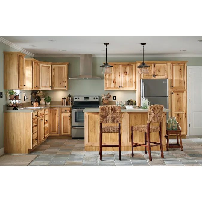 a kitchen filled with lots of wooden furniture