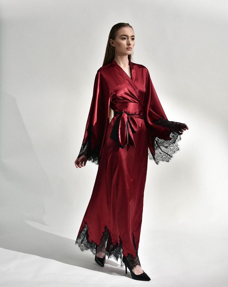 Irresistible in its classic cut, the silk kimono robe with lace embellishments exudes passion. Crafted from silk and satin blend, it features a dramatic, long sweeping hem and draped sleeves, creating a captivating silhouette reminiscent of old Hollywood glamour. The broad obi-style sash draws the waist for a polished profile, making it the epitome of sophistication and a luxurious start to every morning. ✓ garment length - 147 cm/58'' ✓ wrap over style ✓ two sets of inside ties ✓ wide obi-tie i Luxury Satin Gown, Luxury Long Sleeve Silk Gown, Luxury Gown With Satin Finish, Elegant Silk Wedding Night Gown, Luxury Silk Gown With Satin Finish, Luxury Wedding Gown With Satin Finish, Elegant Silk Robe With Kimono Sleeves, Elegant Satin Robe With Kimono Sleeves, Elegant Silk Dress With Kimono Sleeves