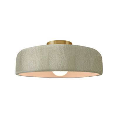 an image of a modern light fixture on a white background with gold trimmings