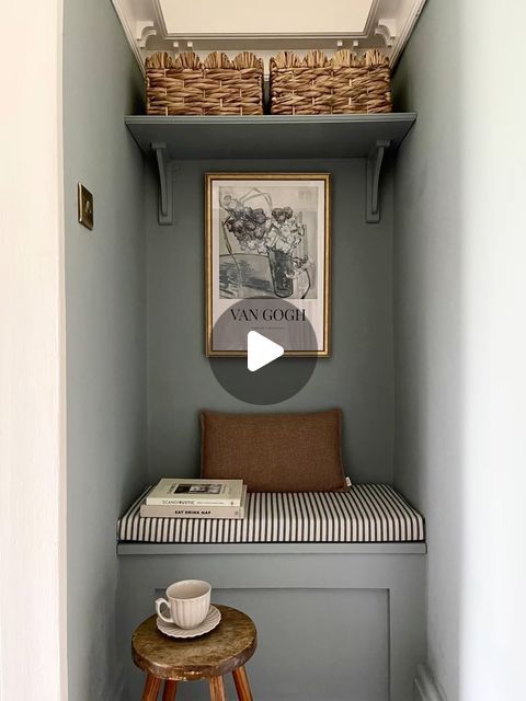 a room with a bench, coffee cup and basket on the shelf next to it