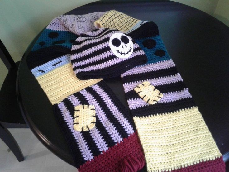 a crocheted scarf with a skull on it sitting on top of a table