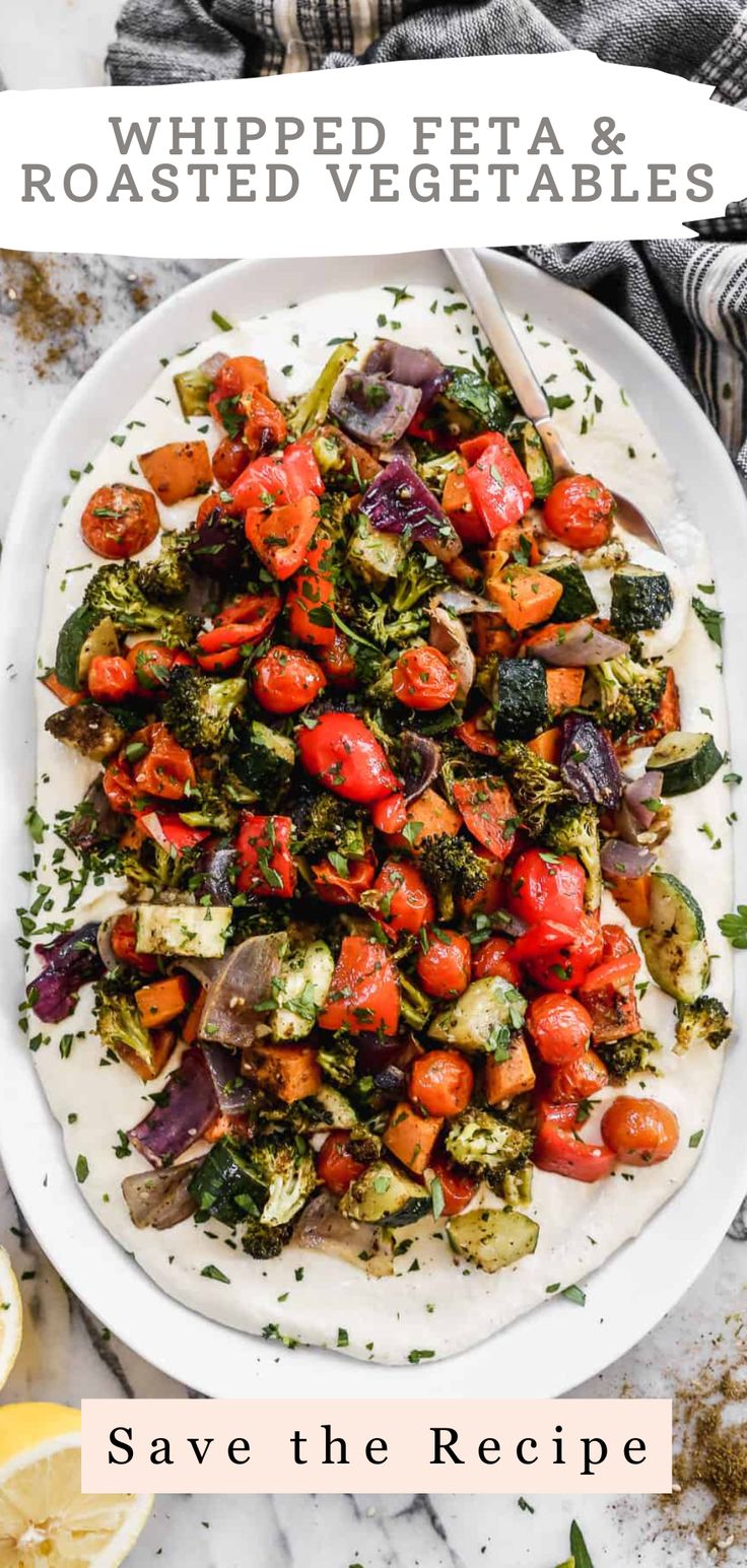 a white plate filled with roasted vegetables on top of a table