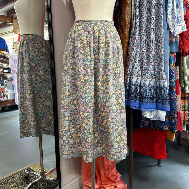 Approximate Size UK 12  composition: 82% cotton 18% wool  Pretty vintage floral midi skirt in a soft pastel colour way.  Approximate Measurements  Waist 29" Length 30" Relaxed Floral Print Skirt For Daywear, Vintage Floral Print Bottoms For Spring, Vintage Flared Skirt For Spring, Vintage Relaxed Skirt For Spring, Floral Print Relaxed Fit Skirt For Daywear, Vintage Relaxed Fit Skirt For Spring, Floral Print Full Skirt For Daywear, Vintage Spring Lined Skirt, Vintage Lined Skirt For Spring