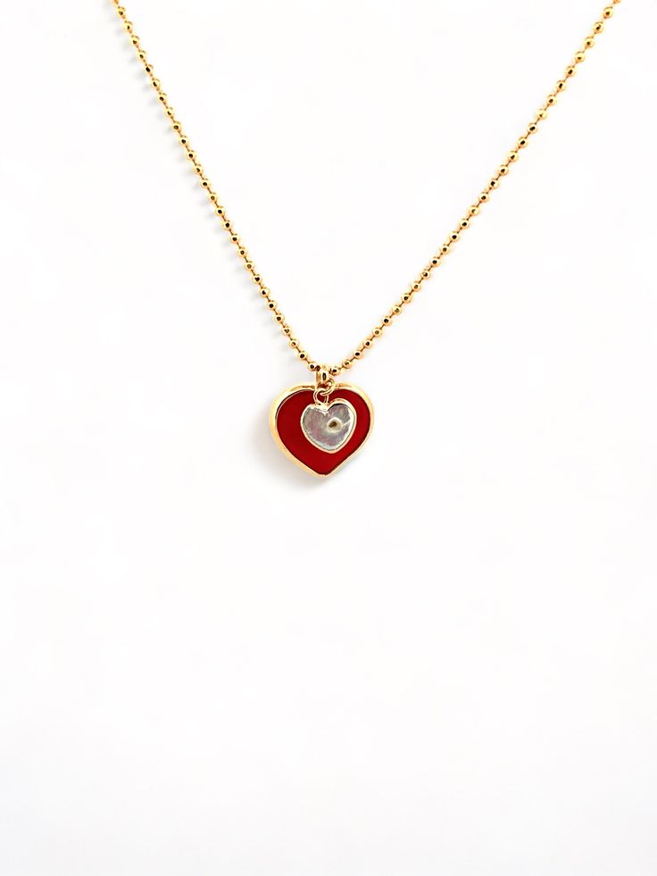 Give the special mom and daughter in your life an elegant and exclusive reminder of their bond with this gorgeous Mommy and Me Heart Necklace. Two delicate hearts, one in luxurious red and the other crafted from mother of pearl, hang from a dainty gold chain for a beautiful mother-daughter accessory. The perfect gift for an unforgettable bond. Elegant Red Heart Necklace With Birthstone, Elegant Red Heart Birthstone Necklace, Valentine's Day Red Charm Necklace, Red Dainty Charm Necklace With Heart Charm, Luxury Double Heart Necklace For Gift, Red Charm Necklace For Gift, Dainty Red Heart Charm Necklace, Dainty Red Heart Necklace With Charm, Dainty Red Heart Necklace With Heart Charm