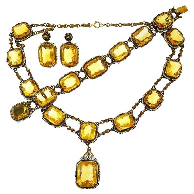 Beautiful Victorian set made of 14 karat (stamped) yellow gold, featuring nineteen emerald mixed cut citrines (approximately 200 carats total) accented with seed pearls. Measurements: necklace 15" x 5/8" (37.5 x 1.6 cm), pendant 1 3/8" x 3/4" (3.3 x 2 cm); bracelet 7" x 3/4" (17.5 x 1.6 cm); earrings 1 1/8" x 3/4" (3 x 1.6 cm). Weight: necklace 57.7 grams, bracelet 32.6 grams, earrings 12.4 grams. Stamped with hallmarks for 14 karat gold. Feminine, exquisite and timeless, the set is a great addition to your jewelry collection. Antique Gold Citrine Jewelry, Antique Citrine Gold Jewelry, Gold Gemstone Jewelry For Evening, Antique Yellow Gold Jeweled Jewelry, Antique Jeweled Yellow Gold Jewelry, Rectangular Faceted Yellow Gold Jewelry, Victorian Gold Faceted Jewelry, Vintage Yellow Gold Citrine Jewelry, Victorian Yellow Gold Jeweled Jewelry