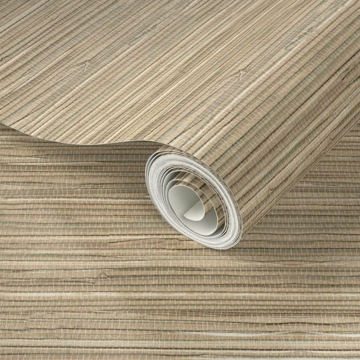 a close up view of a beige wallpaper with vertical stripes and a roll of tape