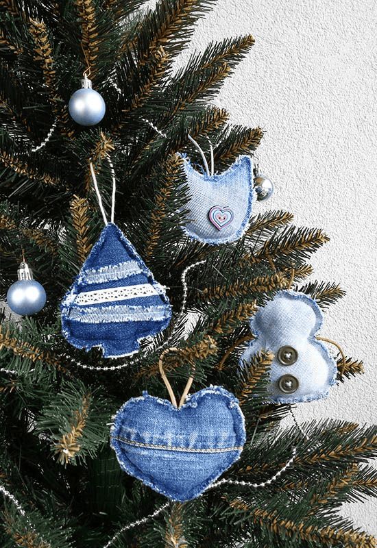 a christmas tree with blue ornaments hanging from it's branches and two birds on top