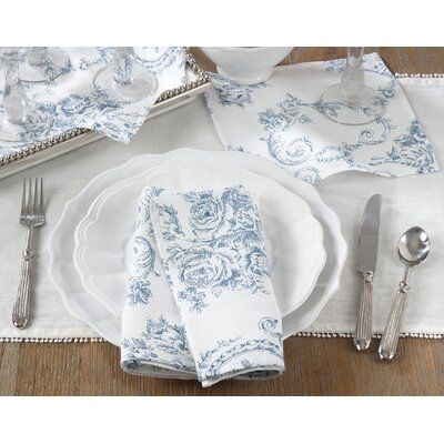 a white and blue place setting with silverware