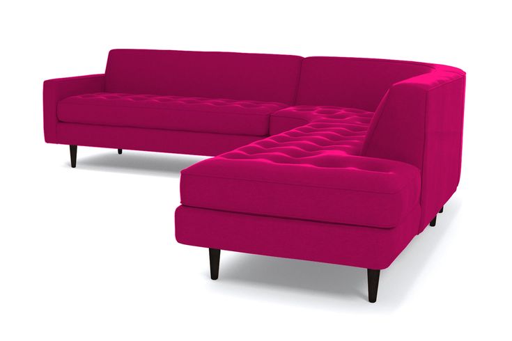 a pink couch and footstool sitting next to each other on a white background