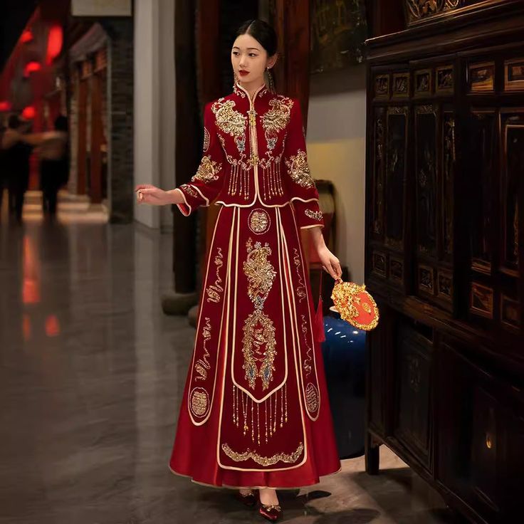 Indulge in a traditional Chinese bridal gown with this stunning 2-piece qun kwa set, adorned with beads and sequins and intricate embroidery in gold, silver, and white. The embroideries of flowers and Chinese double happiness are carefully placed throughout the jacket and skirt. Perfect for a traditional Chinese wedding or tea ceremony. Plus sizes are available for this style. Size Guide: Please refer to the size guide picture before placing the order. Please leave your Height, Weight and Bust m Traditional Drape Dress With Gold Embroidery For Ceremonies, Gold Embroidered Dresses For Traditional Ceremonies And Festivals, Traditional Ceremony Gown For Festivals, Festive Gown With Gold Embroidery For Traditional Ceremonies, Traditional Dresses With Pearl Embroidery, Traditional Floor-length Dress With Pearl Embroidery, Traditional Wedding Gown With Pearl Embroidery, Floor-length Gown With Gold Embroidery For Traditional Ceremonies, Floor-length Gown With Gold Embroidery For Ceremonies