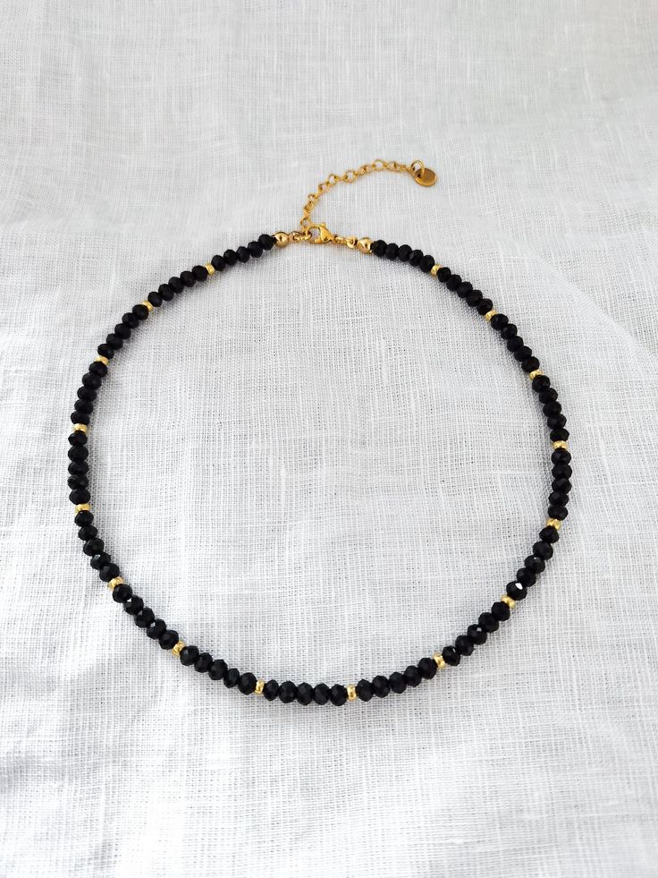 Trendy choker necklace with black and gold glass beads and a stainless steel clasp. The black glass beads are 4x3 mm. The little golden glass beads are 3 mm big. The clasp and the extension chain are made of stainless steel. The standard length for the necklace is 34 cm (+ 5 cm). The necklace is worn as a choker (please see the pictures). If you like your necklaces longer or more lose you can choose a different length when you order. Every necklace is handmade in Germany after your order and packed with love.  I recommend taking off your jewelry while taking a shower or working out and to keep it free off sweat, cream, perfume etc. Please find more of my handmade jewelry in my Etsy Shop: https://www.etsy.com/de/shop/bracelens Minimalist Black Beaded Choker Necklace, Minimalist Gold Necklace With Black Beads, Minimalist Gold Beaded Necklace With Black Beads, Minimalist Black Jewelry With Gold Beads, Black Beaded Necklace With Gold Beads As Gift, Minimalist Black Beads As Gift, Minimalist Black Beads For Gifts, Minimalist Black Beads For Gift, Dainty Black Beaded Necklace Gift