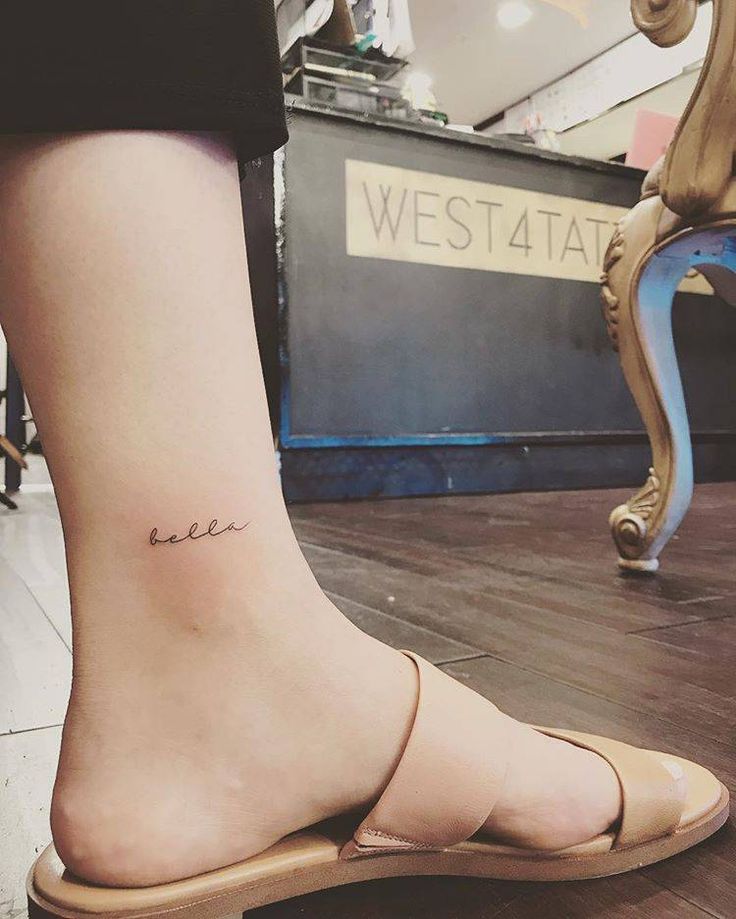 a woman's foot with a small tattoo on her left ankle and the word love written in cursive font