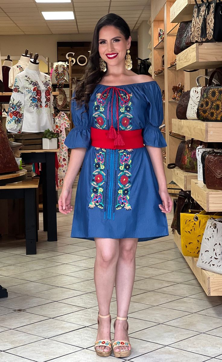 This Beautiful Off the Shoulder Mexican Campesino Dress is the perfect Spring & summer dress. It's lightweight with elastic around the shoulder, made out of a light jeans material and is full of vibrant colors. The belt shown with this dress is included. Available size: S - 2XL Spring Vacation Embroidered Sundress, Summer Vacation Embroidered Dresses, Casual Spring Dresses With Embroidery, Embroidered Summer Mini Dress, Embroidered Mini Summer Dress, Summer Embroidered Cotton Mini Dress, Casual Floral Embroidery Beach Dress, Casual Beach Dresses With Floral Embroidery, Casual Cotton Boho Dress With Floral Embroidery