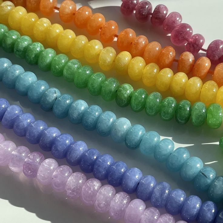 "Planning to knot with Size 8 Griffin silk? These beads are perfect for all knotting and finishing techniques!  These 8mm smooth rondelles are made of Quartz and dyed to get these deliciously vibrant colors. These beads have an ultrasonically drilled 1mm hole, so they're easy to string, even on stretch bracelets, memory wire, leather and heavier cording. Details: Stone: Natural Quartz / Quartzite (See Gem Geek Notes for More) Strand Length: Approximately 15\" Shape: Rondelle Features: Smooth / Plain  Treatment: Dyed Bead Snob Notes: Cord Sizing: Plan to use a minimum of a Size 6 - although I think a 7 or 8 will be best. Beading Wire: My vote would be for a \"medium\" Soft Flex or Soft Touch. Gauged Wire: I'd vote for a 22 gauge, but a 20 or even an 18 could work. Gem Geek Notes: I'm of the Rainbow Jewelry With Round Beads, Rainbow Spacer Beads, Rainbow Round Beaded Jewelry, Rainbow Round 8mm Beaded Jewelry, Rainbow Spacer Beads For Jewelry Making, Rainbow Polished Round Bead Jewelry, 8mm Rondelle Beads For Jewelry Making, Multicolor 8mm Beads, Gems And Cabochons, Adjustable Gemstone Round Beads