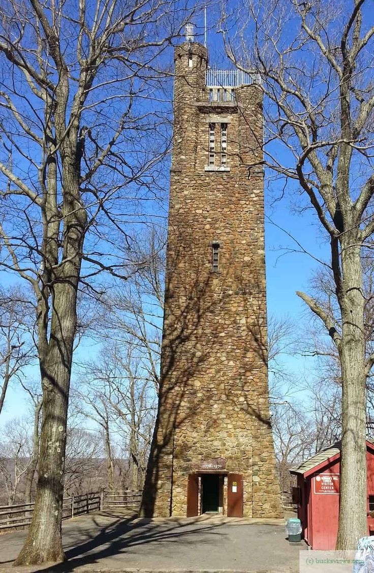 a tall brick tower sitting between two trees