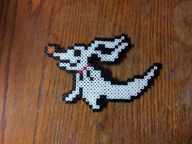 a dog made out of perler beads on a wooden table