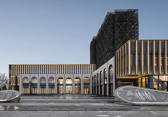 an empty courtyard in front of two large buildings