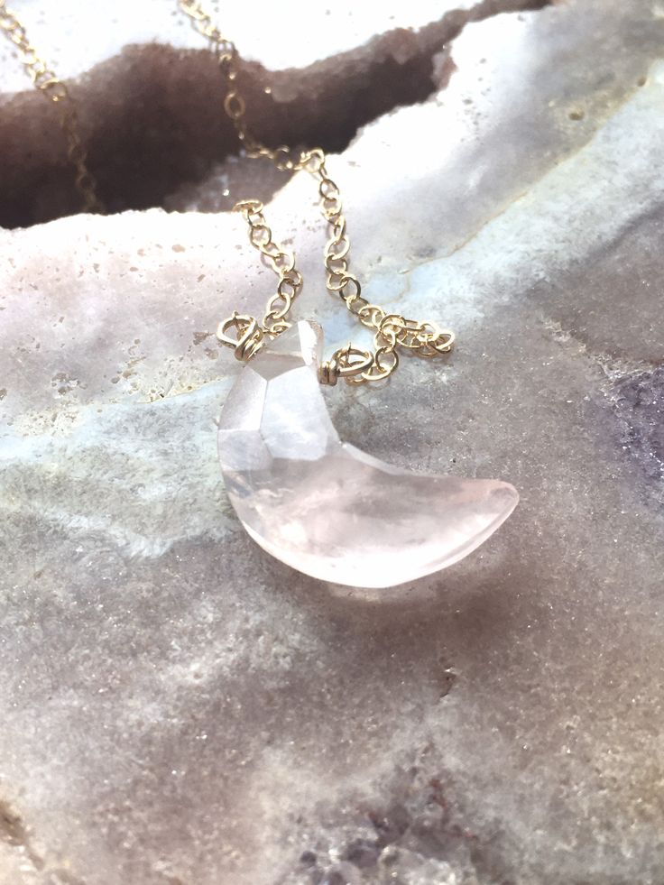 18mm Pretty in pink. This rose quartz moon crystal pendant necklace is the perfect healing piece to add to your jewelry collection. Exuding dusty soft shades of pink, rose quartz helps soothe your heart and emit love to those all around you. Embrace the delightful beauty and tranquil benefits of this gentle and graceful creation. Pink Rose Quartz Crystal Pendant Necklace *Beautifully faceted and carved to a moon shape *Soft and feminine style *Loving calm energy -- speaks directly to your heart Pink Moonstone Jewelry Gift, Delicate Pink Rose Quartz Crystal Necklace, Pink Moon Charm Jewelry, Pink Round Moon Charm Jewelry, Minimalist Pink Rose Quartz Jewelry, Pink Moon-shaped Jewelry With Moon Charm, Pink Moon-shaped Jewelry Gift, Pink Rose Quartz Round Necklaces, Pink Moon Shaped Jewelry Gift