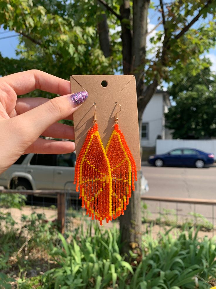 A pair of orange slice beaded tassel earrings! Pierced and clip-on styles available. Each earring features a beautifully intricate beaded design, carefully arranged to resemble the fruit. Handcrafted with attention to detail, the earrings are vibrant, making them a statement piece that will surely catch the eye. They are lightweight, ensuring hours of comfortable wear without compromising on style. ♥ Hypoallergenic. Nickel-Free and Lead-Free. 🍊Orange Earrings Measurements & Weight: - 9cm drop l Summer Orange Tassel Earrings Gift, Orange Beaded Dangling Earrings For Summer, Summer Orange Beaded Dangling Earrings, Orange Dangling Beads Earrings For Beach, Orange Beaded Fringe Jewelry For Festival, Orange Adjustable Beaded Earrings For Festival, Adjustable Orange Beaded Earrings For Festival, Summer Festival Orange Earrings, Beaded Fringe Teardrop Earrings As Gift