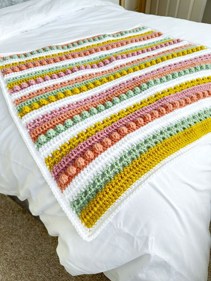 there is a crocheted blanket on the bed