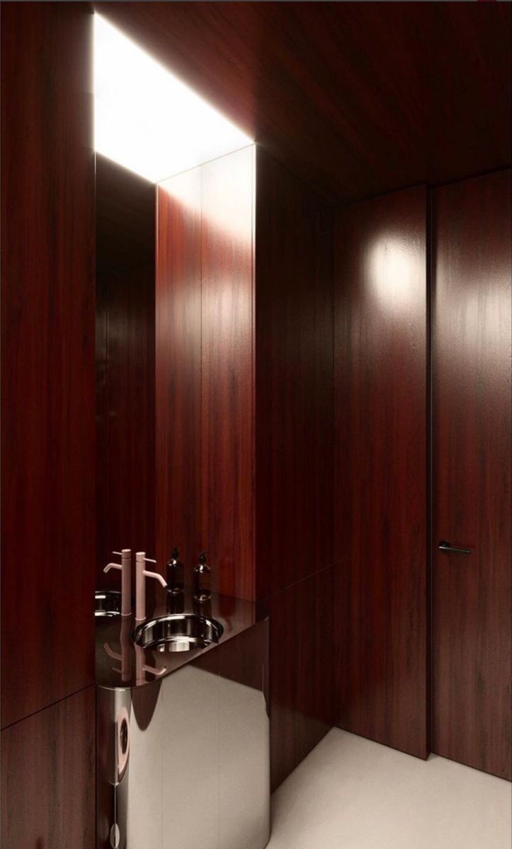 a bathroom with dark wood walls and white flooring is pictured in this image, there are two sinks on each side of the wall