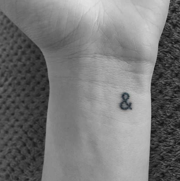 a woman's wrist tattoo with the number 8 on her left hand and an eight in the middle