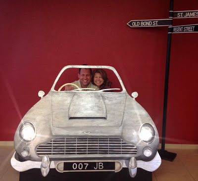 a man and woman sitting in a silver car