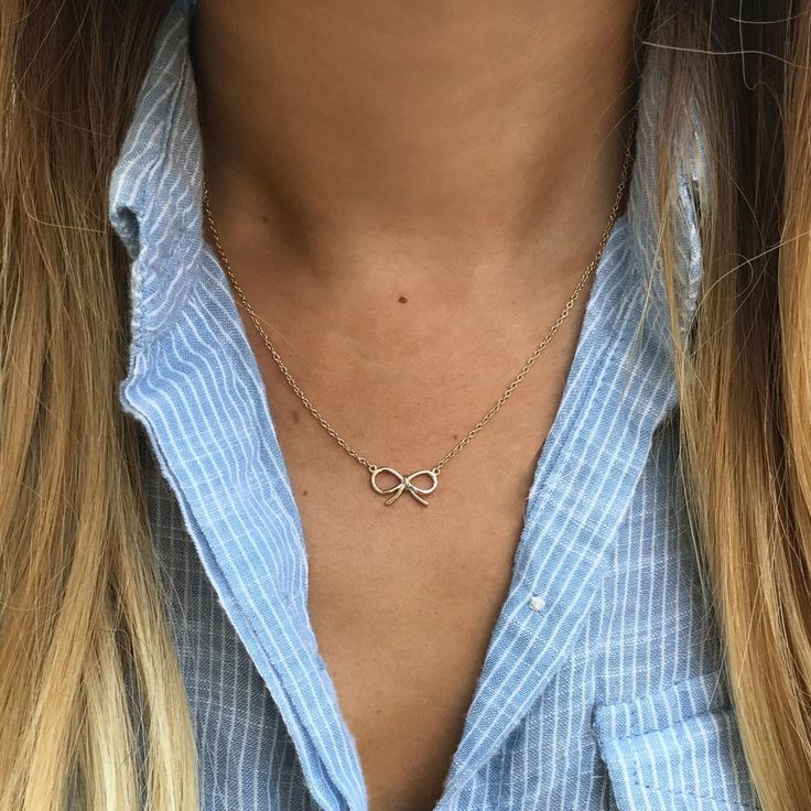 This necklace features a dainty bow pendant on a delicate, diamond-cut cable chain from our signature O Collection. Pair it with other necklaces from this collection. Our patented connectors let you easily link and layer necklaces in any order you desire. Knot: Width 0.6in (1.5cm) x 0.4in (1cm) Adjustable chain: 17-19in (43-48cm) When layered, chain length is: 17-23in (47-58cm) Learn more Gold Vermeil Spring clasp closure Hypoallergenic, lead and nickel free #265G Elegant Sterling Silver Charm Necklace With Cable Chain, Delicate Charm Necklace With Cable Chain, Elegant Charm Necklace With Rolo Chain As Gift, Elegant Infinity Cable Chain Necklaces, Chic Charm Necklace With Cable Chain For Gifts, Rolo Chain Necklace For Anniversary, Chic Cable Chain Charm Necklace Gift, Sterling Silver Necklace With Rolo Chain, Layer Necklaces