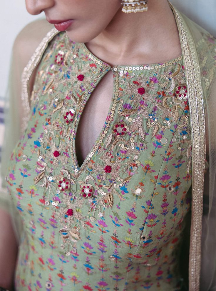 Editor's Note Explore a seafoam green printed dupion silk kurta paired effortlessly with printed sharara pants and an embroidered net dupatta. A blend of prints and hand-embroidered elegance, perfect for a striking presence at any event. Fabric: Dupion silk, net Color: Green Components: Kurta, sharara and dupatta Occasion: Festive Disclaimer: Product color may slightly vary due to photographic lighting sources or your monitor setting. Care: Dry clean only About the Designer Drishti & Zahabia rep Embroidery Kurti For Women, Work On Printed Suits, Keyhole Neckline Kurti, Silk Kurtis, Green Sharara, Printed Sharara, Sleeveless Kurta, Sharara Pants, Pakistani Formal Dresses