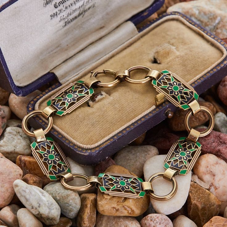 This wonderful antique bracelet features black and green enamel and is crafted of 14k yellow gold. The bracelet has a lovely unpolished patina finish. Luxury Black Enamel Bracelets For Formal Occasion, Luxury Black Enamel Bracelets, Luxury Vintage Bracelets With Stones, Luxury Yellow Gold Bracelets With Black Enamel, Elegant Bronze Jewelry With Patina, Antique Enamel Bracelets For Gifts, Antique Enamel Bracelets As Gift, Elegant Green Jewelry With Black Enamel, Yellow Gold Art Deco Bracelet