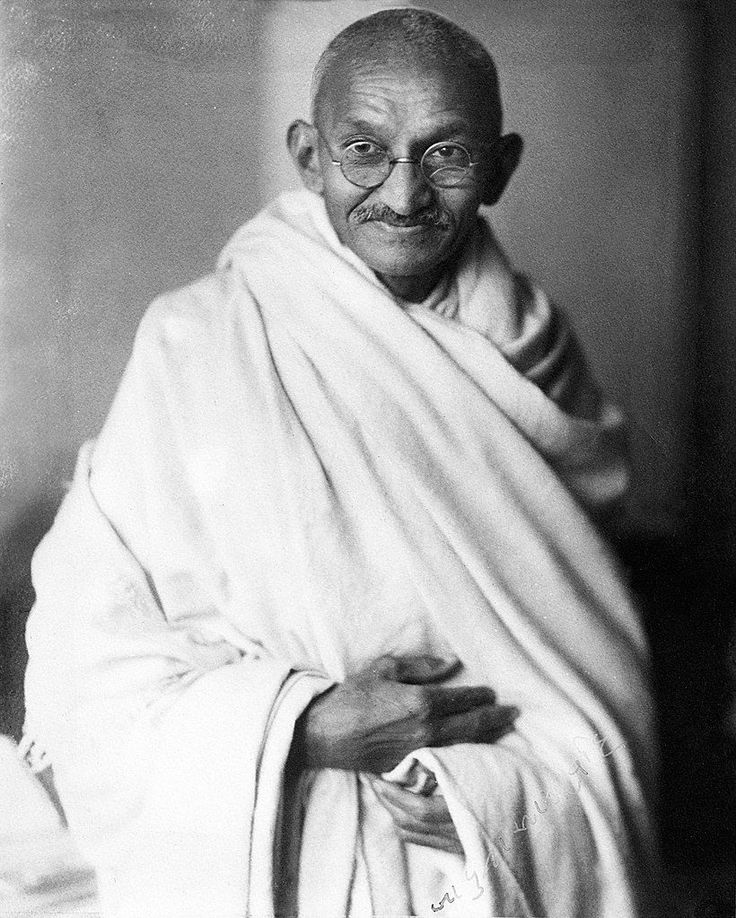 an old black and white photo of a man in a robe with glasses on his head