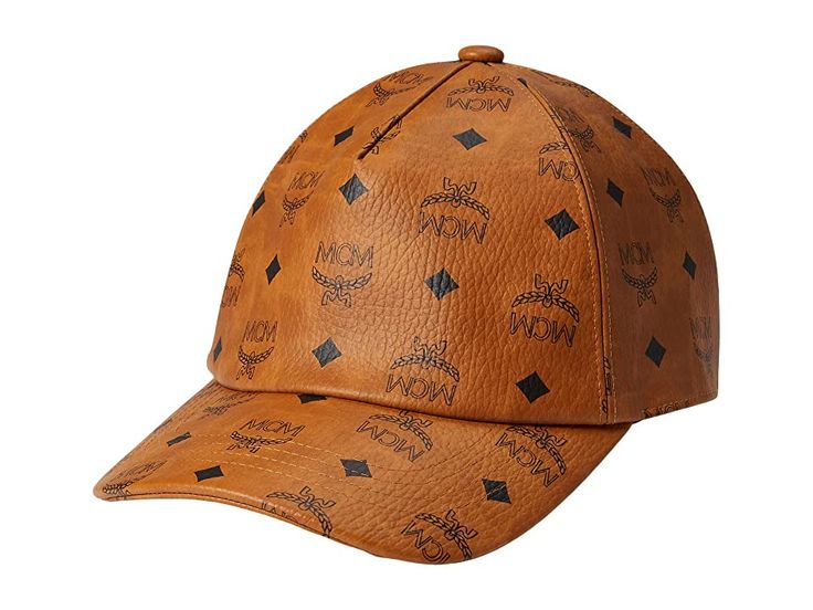 MCM MCM Collection Cap - Caps : Cognac : Get compliments for your elite choice in accessories wearing the MCM Collection Cap. Made of cotton and polyester blend material with PU coating. Allover iconic branded print. Curved brim. Adjustable buckle strap back closure. Viscose lining. Spot clean. Imported. Measurements: Brim: 2 3 5 in Luxury Baseball Cap With Logo Patch, Luxury Hats With Logo Patch And Curved Brim, Designer Brown Hat For Travel, Luxury Baseball Cap With Logo And Curved Brim, Adjustable Flat Brim Baseball Cap With Logo Print, Designer Adjustable Hats For Travel, Designer Brown Visor Baseball Cap, Luxury Adjustable Brown Baseball Cap, Designer Baseball Cap For Travel