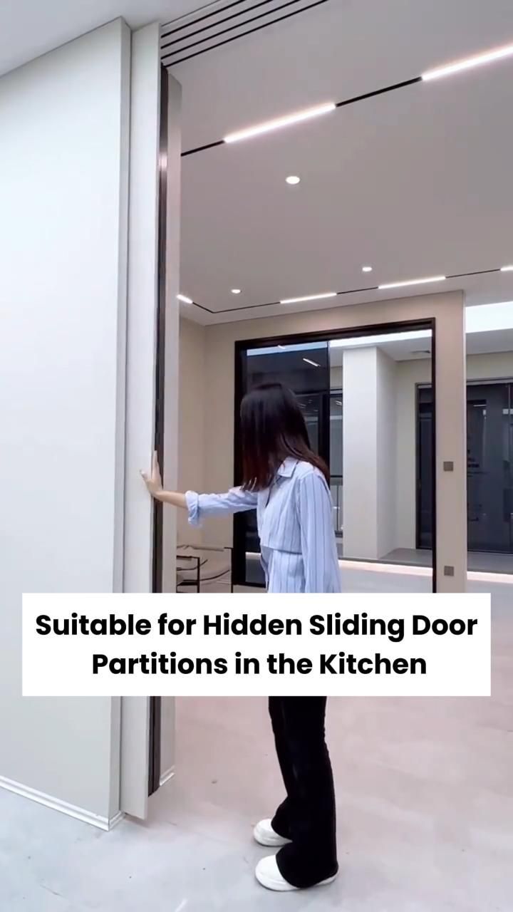 a woman standing in front of a sliding door with the words suitable for hidden sliding door partitions in the kitchen