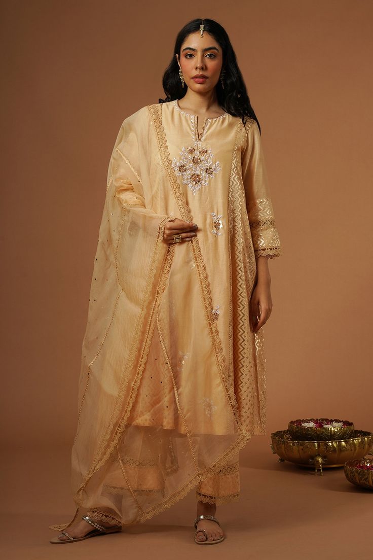 Peach brocade panelled kalidaar kurta with floral, thread and mukaish hand embroidery. Paired with pant and dupatta.
Components: 3
Pattern: Embroidered
Type Of Work: Floral
Neckline: Notched v neck
Sleeve Type: Three quarter
Fabric: Silk Chanderi
Color: Peach
Other Details: 
Lace detailing
Floral embroidery
Occasion: Mehendi and Haldi - Aza Fashions Peach Resham Embroidery Traditional Wear For Festive Occasion, Festive Peach Traditional Wear With Resham Embroidery, Elegant Peach Traditional Wear For Festive Occasions, Elegant Peach Traditional Festive Wear, Traditional Peach Wear With Zari Work In Traditional Drape, Traditional Peach Wear With Zari Work, Peach Traditional Drape Wear For Festive Occasions, Peach Traditional Wear For Festive Occasions, Festive Peach Traditional Wear With Traditional Drape