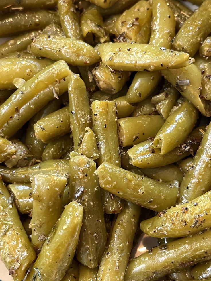 cooked green beans with seasoning on the side