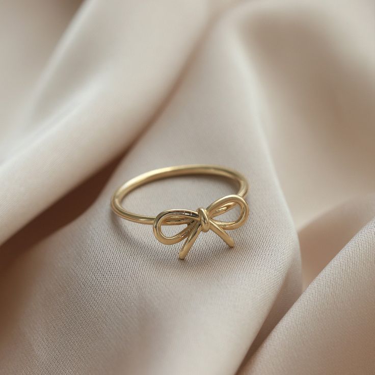 Ⓜ 14K Gold Bow Infinity Ring The bow ring in its minimal desing with the infinity symbol symbolizing innocence is one of the most beautiful gift options you can buy for yourself or your loved ones ⓂMaterials & Specifications : 14K Gold Bow Ring Ring Width : 7,21 mm (0.28 in) Ring Length : 13,61 mm (0.53 in) 3 Colours are in options. Check out our return policy for personalized products. Personalized order group All rings made to be custom made. Ring Aesthetic Minimalist, Bow Gold Ring, Cute Ring Designs, Ins And Outs List, Bow Ring Gold, Jewelry Gold Aesthetic, Gold Rings Dainty, Hold Jewelry Aesthetic, Cute Jewelry Aesthetic