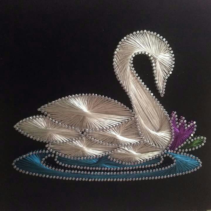 a swan made out of metal wire on a black background