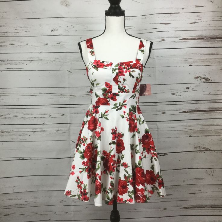 Ixia Junior’s Retro Style Fit & Flare White Dress With Red Floral Print. Tie At Waist, Zip Closure At Back. Chest Area Is Lined With Built In Bra Pads. Made In Usa. Size M Junior New With Tag. Approx. Measurements: Chest 16.5" Waist 14" Length 32" #7 Red A-line Floral Dress For Summer, Fitted Red Floral Dress For Summer, Red Fit And Flare Summer Dress, Fitted Red Floral Dress For Spring, Red Fitted Floral Dress For Garden Party, White Cotton Fit And Flare Mini Dress, A-line Mini Dress For Spring Holiday, Red A-line Floral Summer Dress, Spring Holiday A-line Mini Dress