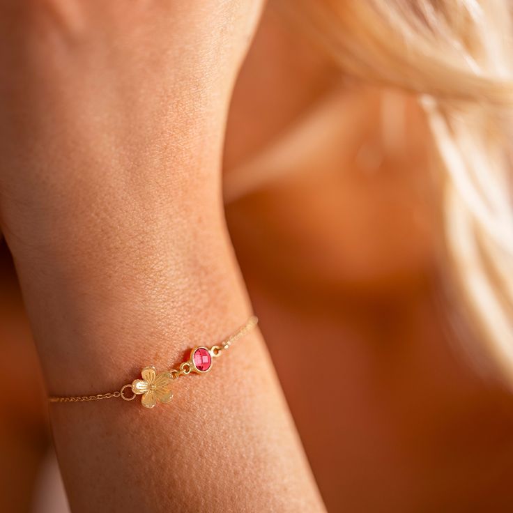 A beautiful personalised bracelet gift featuring a Forget-me-knot flower charm and birthstone.  This versatile slider bracelet is available in silver, gold and rose gold, with a choice of birthstones to represent each month of the year.  With its Garnet Swarovski Crystal birthstone charm, this personalised bracelet makes the perfect gift for a January Birthday. Make this Christmas truly special by giving the gift of personalised jewellery, a unique and meaningful present that will be cherished f Adjustable Flower Shaped Gemstone Jewelry, Delicate Gemstone Bracelets For Wedding, Wedding Bracelet Jewelry With Flower Charm, Delicate Flower Charm Bracelet For Weddings, Wedding Jewelry Bracelet With Flower Charm, Delicate Flower Jewelry For Birthday, Dainty Flower Jewelry For Birthday, Adjustable Birth Flower Jewelry For Wedding, Pink Birth Flower Jewelry For Wedding