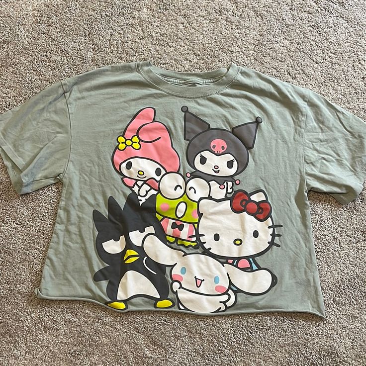 Nwot Sanrio Hello Kitty & Friends Cropped T-Shirt. Short Sleeved. It’s A Light Green Color. Washed But Never Worn. Cute Green Tops With Graphic Print, Hello Kitty Print Crew Neck Top For Streetwear, Cute Green Top With Cartoon Print, Y2k Hello Kitty Print Crew Neck Top, Hello Kitty Print Y2k Crew Neck Top, Hello Kitty Cotton Top For Streetwear, Hello Kitty Short Sleeve Top, Trendy Short Sleeve Hello Kitty Top, Hello Kitty Print Short Sleeve Top For Streetwear