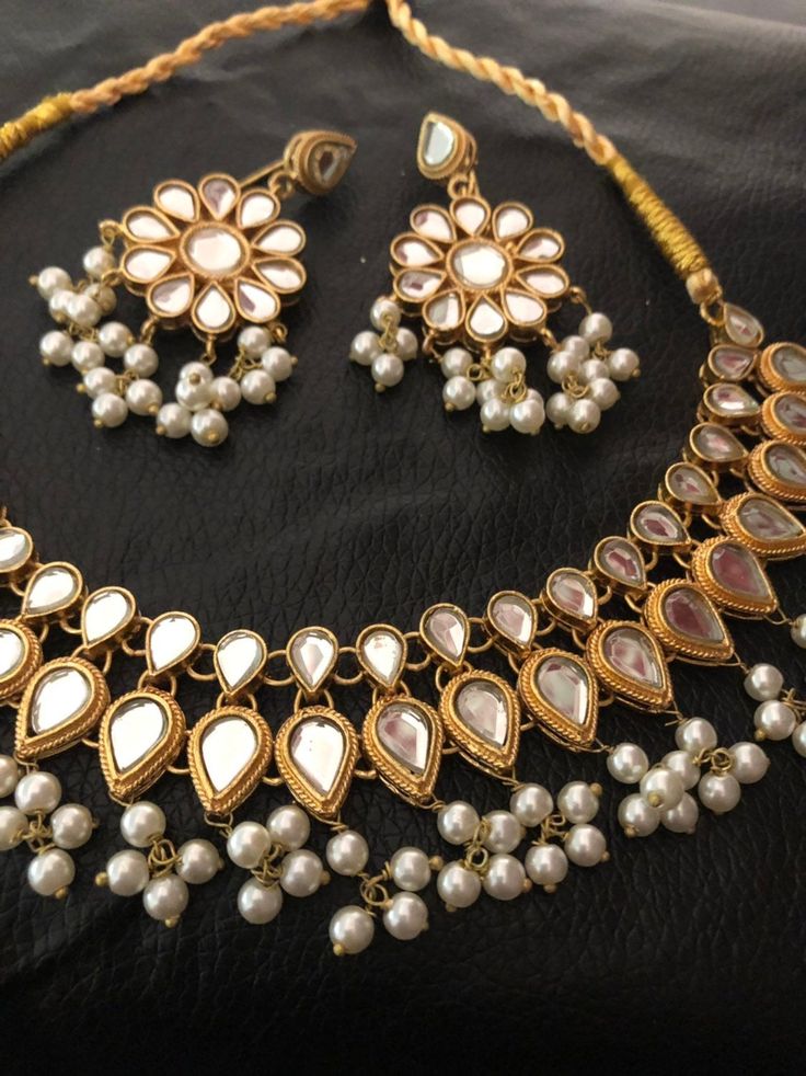 High quality kundan necklace and earrings dipped in 22 karat gold Made to order and shipping time 4 to 6 weeks. Elegant Gold Sets With Mirror Work, Gold Jewelry With Stone Work For Celebration, Gold Kundan Necklace With Stone Work For Festivals, Gold Jewelry With Stone Work For Festivals, Gold Kundan Chandbali Necklace With Stone Work, Gold Kundan Pearl Necklace Hand Set, Handmade Gold Kundan Necklace For Wedding, Elegant Kundan Necklace With Gota Work For Festivals, Gold Bollywood Chandbali Jewelry