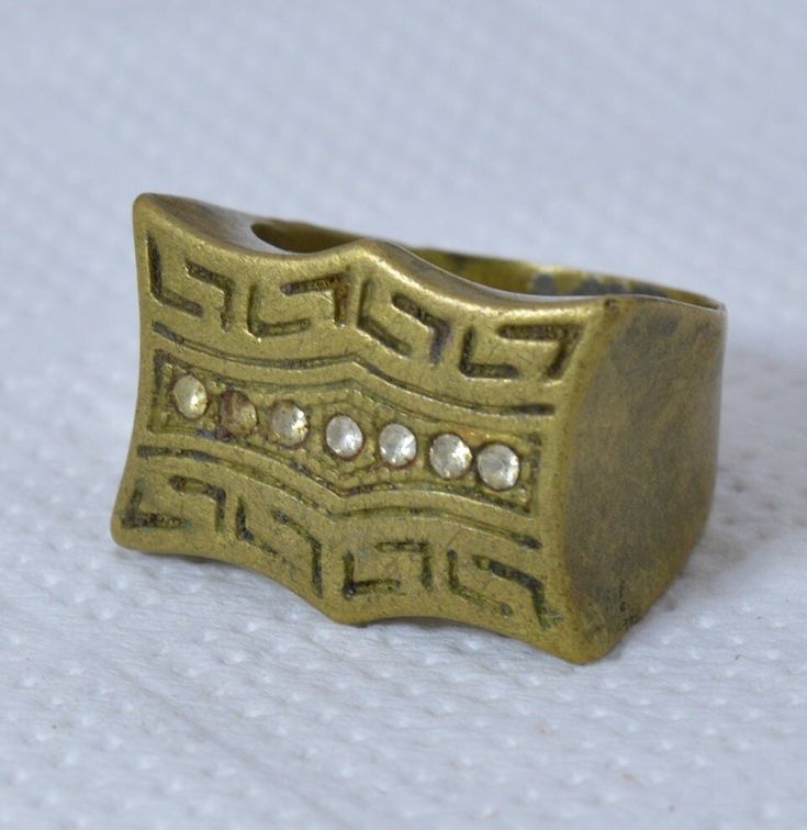 Vintage Moroccan Bronze Ring | Handmade Engraved Berber Jewelry Unique Berber Embrace the allure of Morocco with this exquisite vintage bronze ring. Handcrafted by skilled Berber artisans, this unique piece showcases the rich heritage and artistry of North Africa. Meticulously engraved with intricate patterns, the ring exudes a bohemian charm that effortlessly complements any style. The warm tones of the bronze metal lend a timeless elegance, making it a versatile accessory for both casual and s Vintage Ceremonial Jewelry Metal Ring, Vintage Ceremonial Metal Ring Jewelry, Vintage Gold Metal Rings, Antique Finish Bronze Jewelry For Anniversary, Antique Bronze Jewelry For Anniversary, Bronze Jewelry With Antique Finish For Anniversary, Bronze Antique Finish Jewelry For Anniversary, Antique Brass Open Ring Jewelry, Vintage Open Ring For Ceremonial Occasions