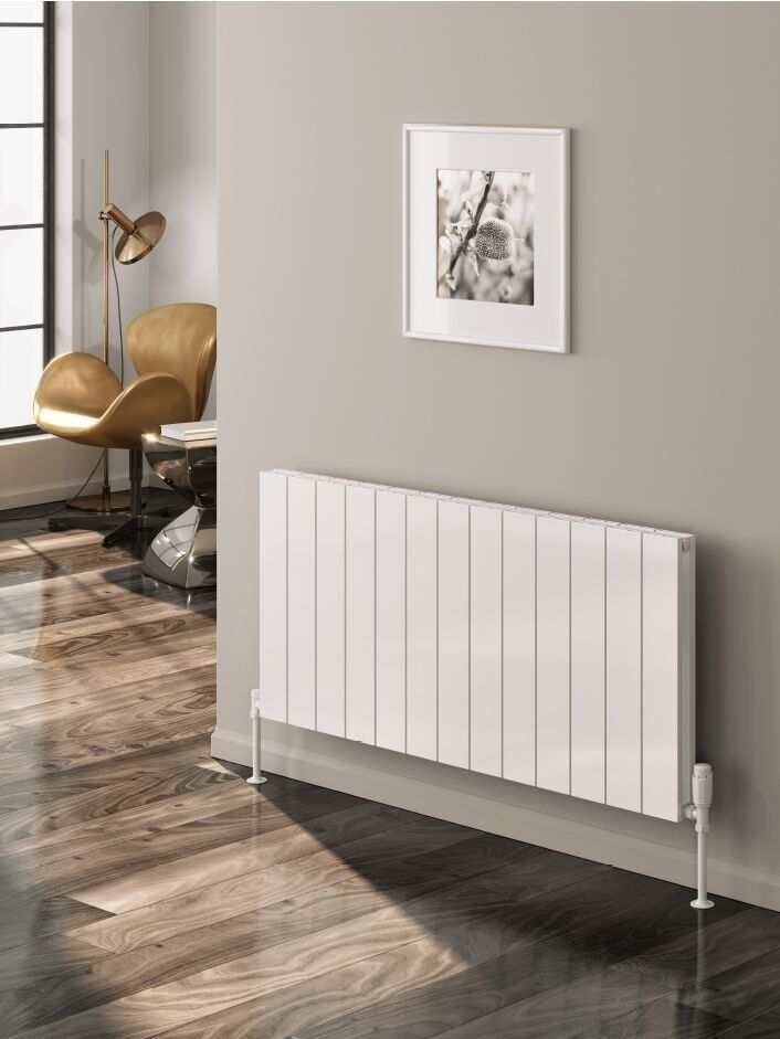 a white radiator sitting on top of a hard wood floor