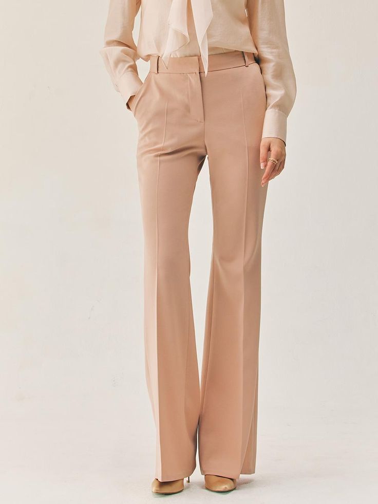 This product features the Vashti bootcut trousers, which are a contemporary update on a classic style. The trousers boast a flattering bootcut silhouette that gently flares from the knee to hem, creating an elongated look. Tailored to perfection, these trousers sit at the natural waist and are designed to offer both comfort and a streamlined appearance. - The bootcut silhouette of these trousers offers a flattering shape that balances proportions and elongates the legs.- Sitting comfortably at the natural waist, they provide a fit that's both secure and stylish.- Tailored construction ensures a polished look, ideal for a professional setting or a sophisticated casual outfit.- These trousers are a versatile staple, easily paired with various tops and shoes for a range of occasions. Elegant Elastane Wide Leg Pants, Elegant Flare Dress Pants For Formal Occasions, Elegant Flare Bottoms For Formal Occasions, Elegant Tailored Flare Pants, Elegant Tailored Flare Bottoms, Elegant Flare Dress Pants For Office, Elegant Tailored Wide Leg Flared Pants, Elegant Flare Bottoms For Workwear, Classic Flare Wide Leg Pants For Business Casual