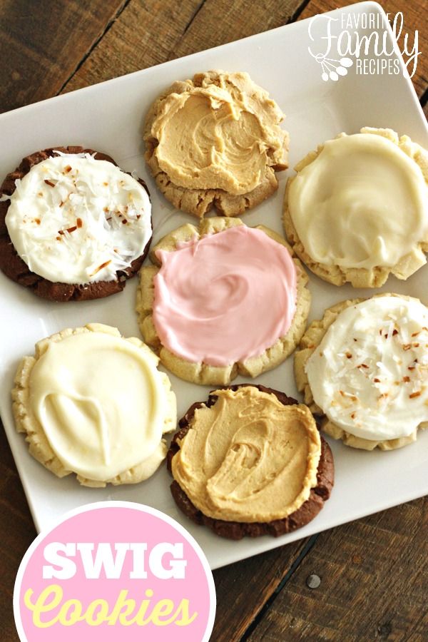 there are many cookies with frosting on the top one is white and has pink icing