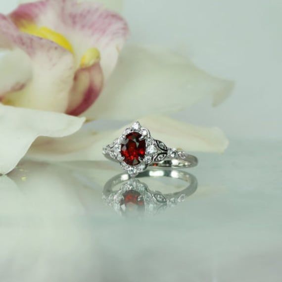 Oval red spinel ring is stunning. Natural spinel gemstone weighs 1.1 carats and has amazing clarity and sparkle. The color of this gemstone is a brilliant red.  Oval red spinel ring has both grace and style. Bonded with rhodium to prevent tarnish. A perfect choice for those with an active lifestyle. Spinel is very durable and handles day to day wear and tear beautifully. Spinel is an 8 on the harness scale comparable in durability to a sapphire. This gem is not treated in any way. Spinel is a st Exquisite Ruby Ring With Gemstone Accents For Anniversary, Exquisite Ruby Ring With Gemstone Accents For Wedding, Heirloom Ruby Ring With Gemstone Accents, Exquisite Ruby Ring With Accent Stones For Wedding, Heirloom Red Jewelry With Gemstone Accents, Red Heirloom Jewelry With Gemstone Accents, Heirloom Red Gemstone Jewelry, Red Gemstone Accented Round Rings, Red Gemstone Accented Anniversary Rings