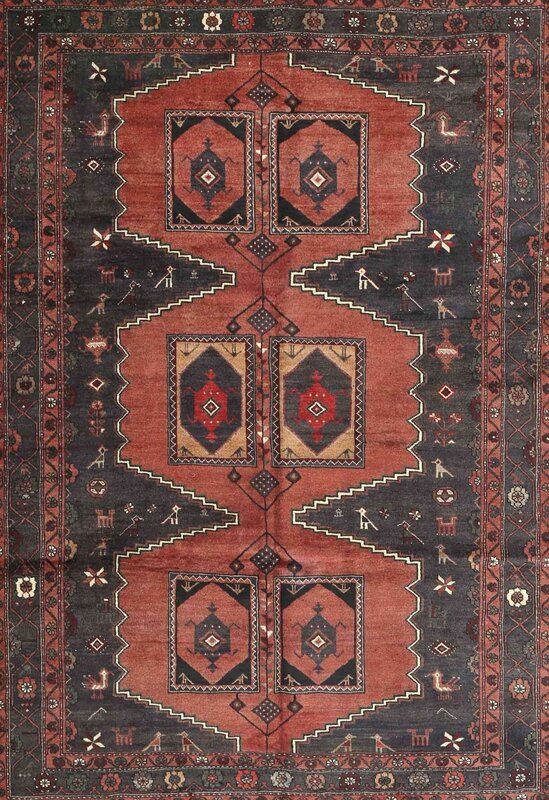 an antique persian rug with red and black colors on the bottom, surrounded by smaller geometric shapes